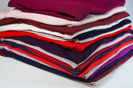 stack of colorful clothes on a white background.