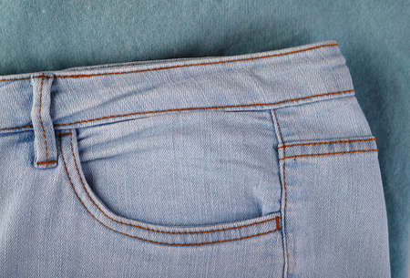 pocket of blue jeans close-up on a knitted background