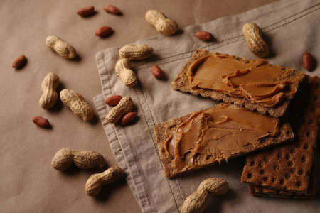 peanut beans and peanut butter crispbread on craft paper