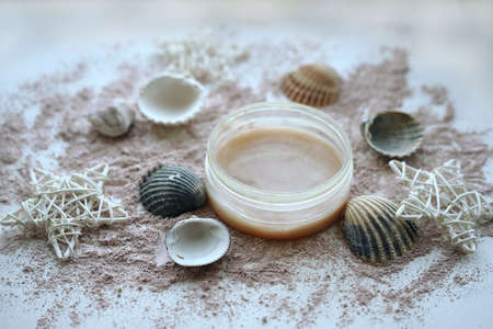Jar of gel decorated with seashells and rattan stars with pink powderの写真素材