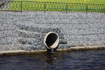 Water outflows in the river on the embarkment through flood drainage system