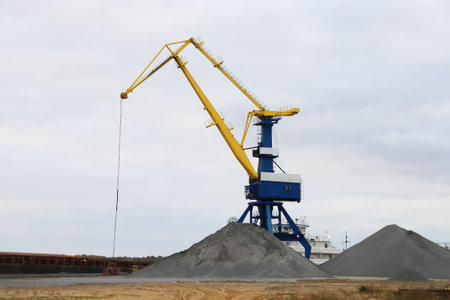 Large crane in the port, crane load gravel. The work of crane in the seaportの写真素材