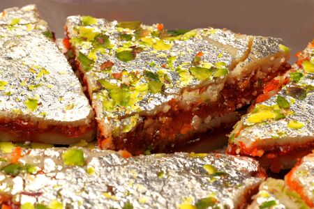 three layeder indian sweet called sangam barfi made from layers of cashew,pistachio nuts and chocolateの写真素材