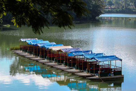 Traditional water boat kept aside of Phewa lake, Pokhara, Nepal with calm environment background.の写真素材