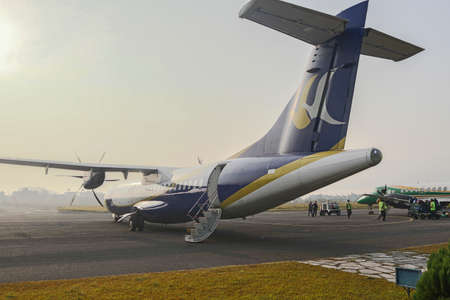Close rear view of a turboprop airplane in Pokhara, Nepal transporting tourists in beautiful Pokhara Airport.のeditorial素材
