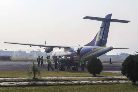 Close rear view of a turboprop airplane in Pokhara, Nepal transporting tourists in beautiful Pokhara Airport.のeditorial素材