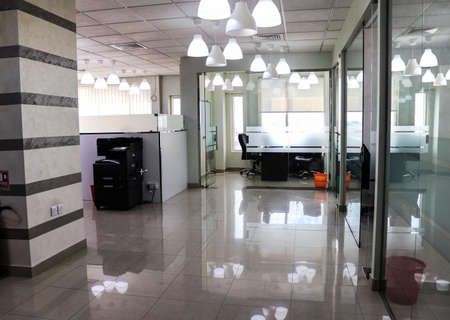 Amazing office interior showing printing devices, lights on the roof and cubicles.のeditorial素材