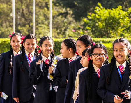 Happy school children posing with their notebooks for camera during their field-visit. School students on their educational tour in Pokhara city of Nepal.のeditorial素材