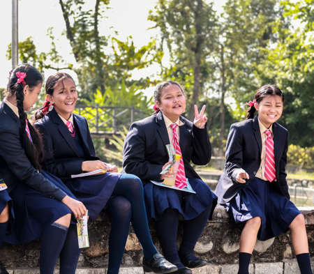 Happy school children posing with their notebooks for camera during their field-visit. School students on their educational tour in Pokhara city of Nepal.のeditorial素材