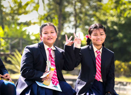 Happy school children posing with their notebooks for camera during their field-visit. School students on their educational tour in Pokhara city of Nepal.のeditorial素材