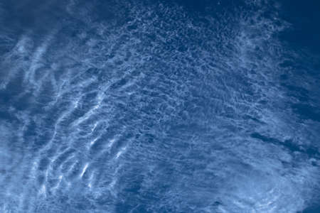 Beautiful blurry pattern of intermittent and scattered clouds on a sunny day with the blue sky as background. Bluish sky color as abstract background or backdrop.の写真素材