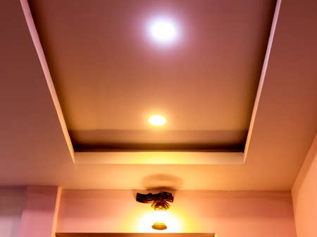 Modern interior design for living room, conference room and hotels. False ceiling co-ply design using gypsum or plaster of paris. Illuminated new home interior with false ceiling lighs.の写真素材