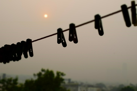 Cloth pegs on a cloth line in the morningの写真素材