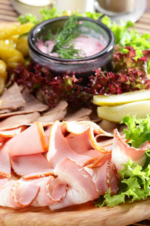 Fresh cold cuts on the wooden plateの写真素材