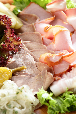 Fresh cold cuts on the wooden plateの写真素材