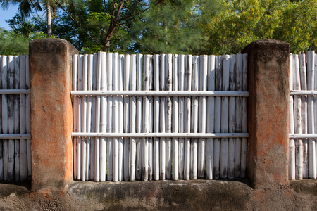 white bamboo fence in a tropical country in the morning sunの写真素材