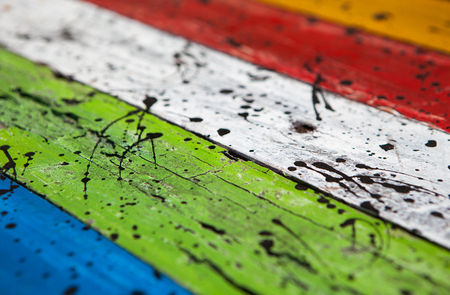 Patterned and textures background of brightly colored panels of weathered painted wooden boardsの写真素材
