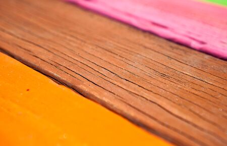 Patterned and textures background of brightly colored panels of weathered painted wooden boardsの写真素材