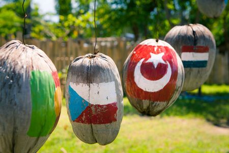 Many flags of countries painted on the hanging coconuts, Czech Republic Turkey Netherlandsの写真素材