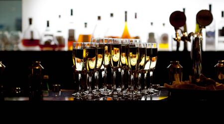 Catering services. Glasses with wine in row background at restaurant partyの写真素材