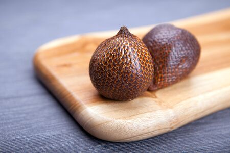 Salak or snake fruit in a wooden textured board, exotic plants