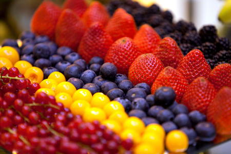 Variety of fresh fruit assortment of raspberries strawberries blueberries currantsの写真素材