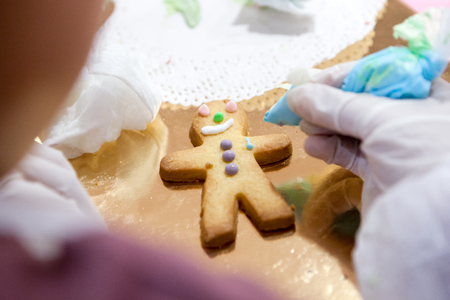 The process of making Sandman the cookies manually apply the glaze of your children's hands close up