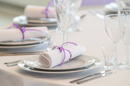 Table setting in a restaurant with napkins and glasses, wedding party
