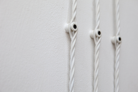 Vintage wiring on white wall, electric wireの写真素材
