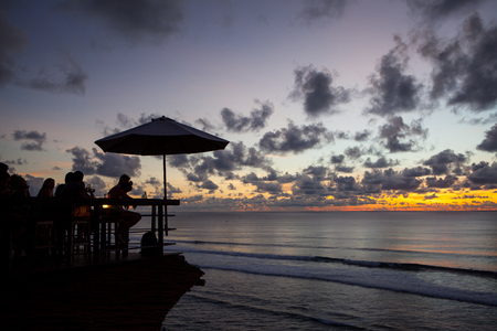 Silhouette of people at bar sunset backgroundの写真素材