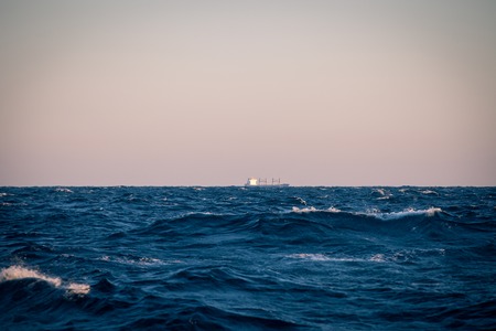 Large sea waves at sunset closeupの写真素材