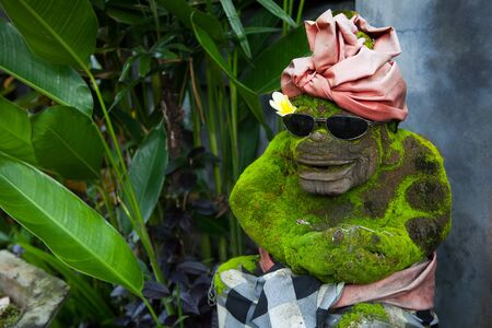 A stone statue of a monkey with glassesの写真素材