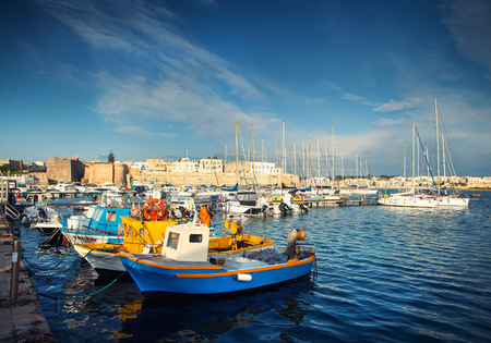 A typical old Italian fishing boats in the portの写真素材