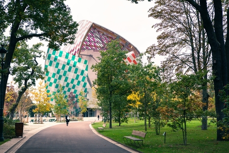 Paris, France - October 19, 2016: the Museum of modern art Foundation Louis Vuitton, view from the Park with walking peopleのeditorial素材