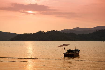 Boat at sea against mountains at sunset, tropical landscape of Thailandの写真素材