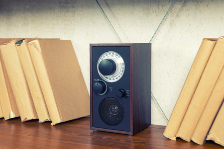 Compact radio on bookshelf in vintage living room interiorの写真素材
