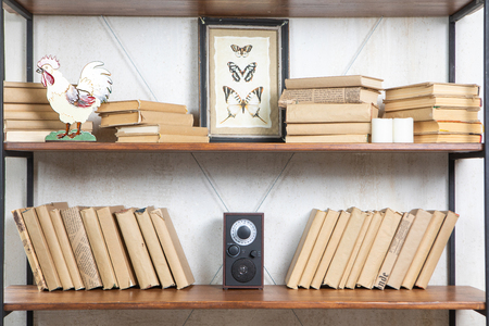Compact radio on bookshelf in vintage living room interiorの写真素材