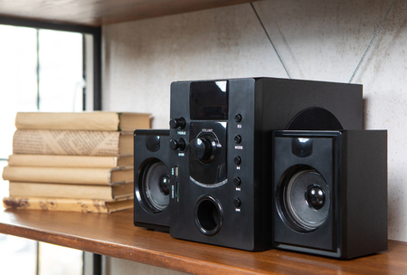Compact music center in vintage residential loft interior on the shelf among books and accessoriesの写真素材