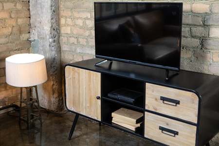 TV in the interior in retro style on the bedside table with decorative itemsの写真素材