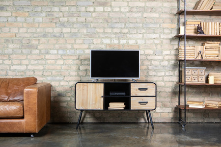 TV in the interior in loft style on the bedside table with decorative itemsの写真素材