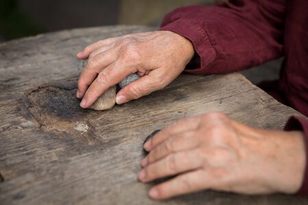 Old womans hands guessing on stone, ancient witch ritualの写真素材