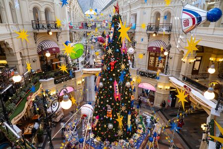 Moscow, Russia - November 25, 2019: New Year tree with cartoon toys in the State Department Store on Red Square. Christmas in the center of Moscow. Design on a space themeのeditorial素材
