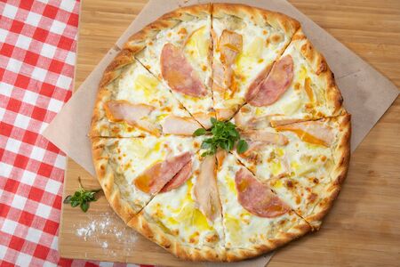 Pizza with different sausages close-up with different ingredients decorated with Basil, an assortment of traditional Italian fast foodsの写真素材