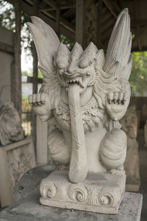 Traditional demon guard statue carved in stone in Bali island.の写真素材
