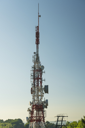 communications tower with antennas against blue skyの写真素材