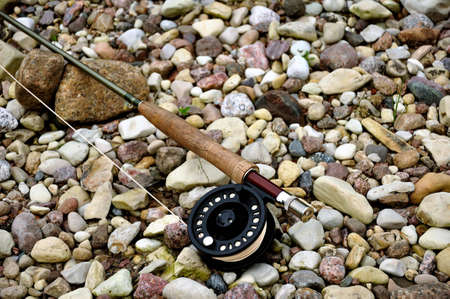 fly rod on the rocksの写真素材