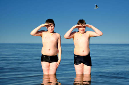 twins brothers in the seaの写真素材