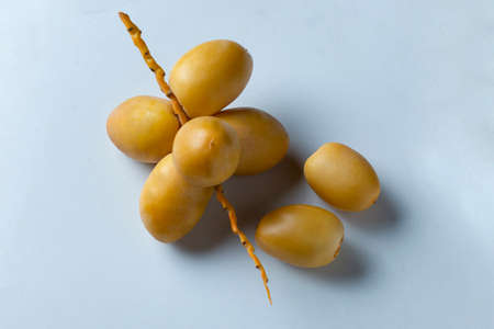 yellow fresh dates fruit on white background