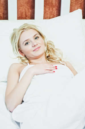 A beautiful girl resting on the bedの写真素材