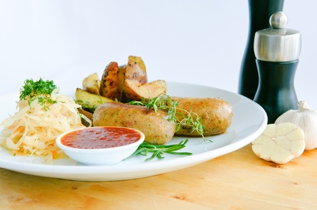 Italian Sausage with wegetables on dish and ketchupの写真素材